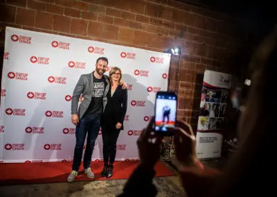 A photo being taken in front of a Start Up Canada backdrop