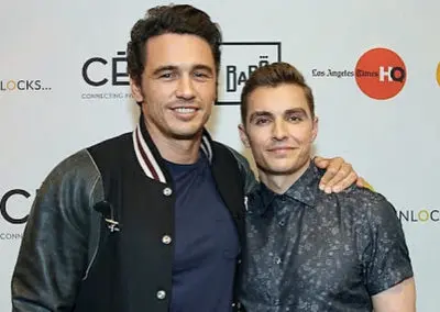 James and Dave Franco in front of a step and repeat backdrop
