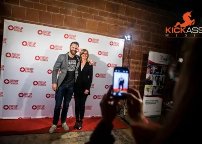 A photo being taken in front of a Start Up Canada backdrop