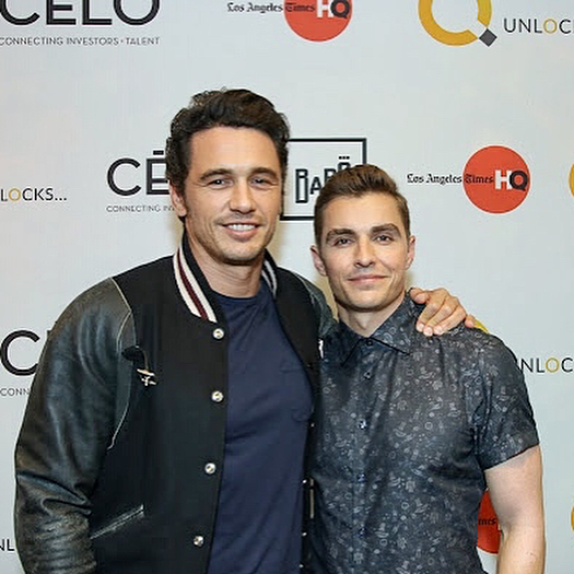 James and Dave Franco in front of a step and repeat backdrop